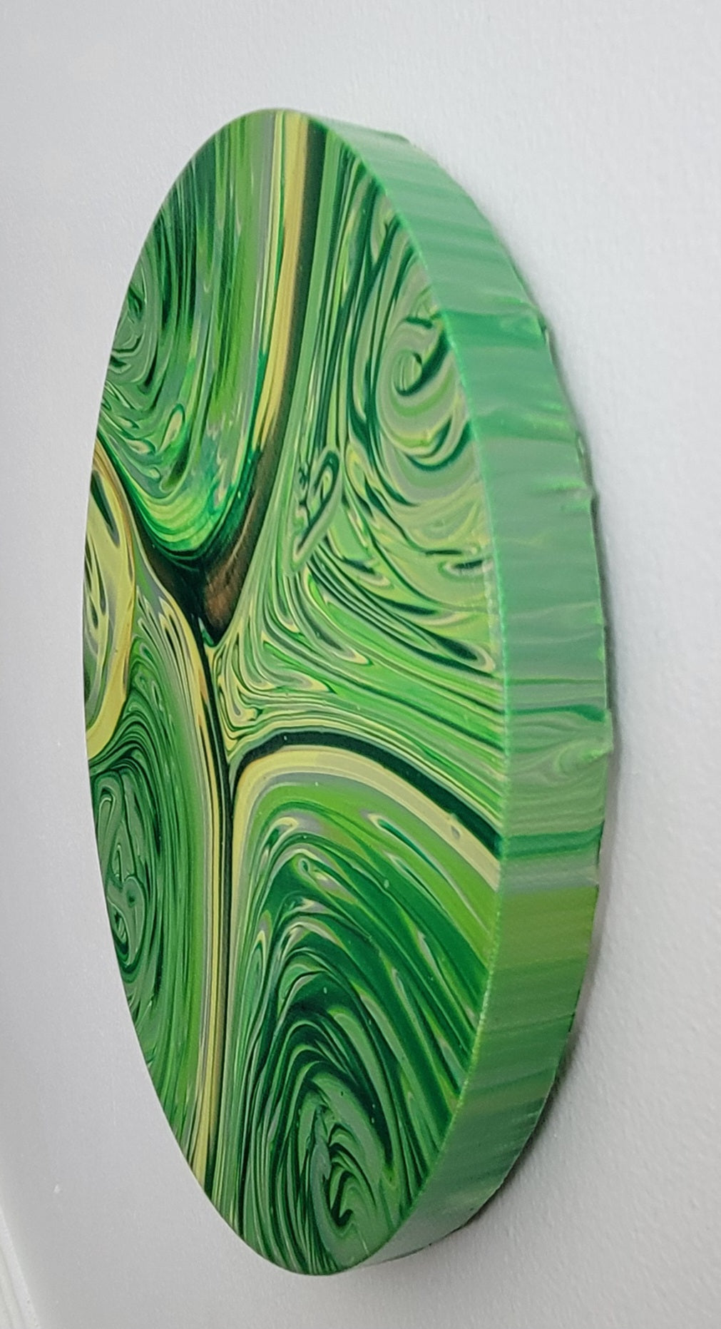 Forest in Motion shown from an angle, with the green-painted canvas edge visible 